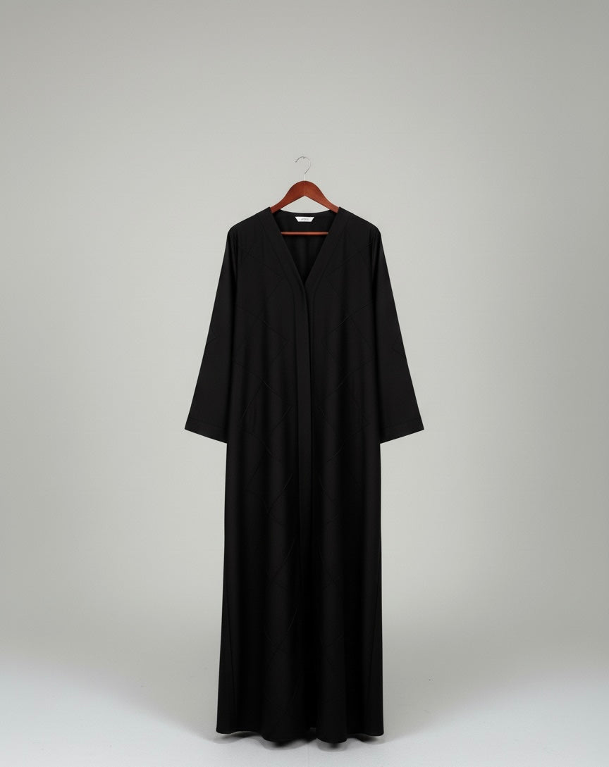 Black abbaya on a hanger against a white background